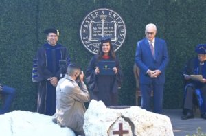 Stephanie during graduation at TMU, with Pastor John MacArthur (right)